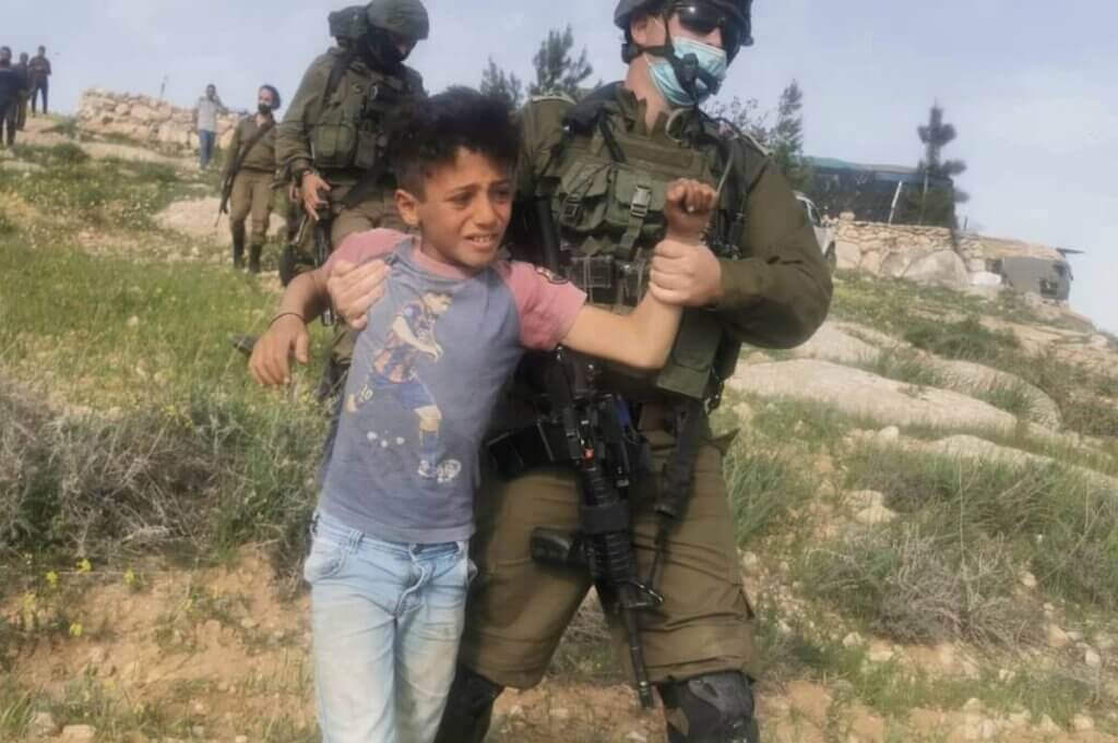 Op aandringen van kolonisten arresteren Israëlische troepen Palestijnse kinderen die wilde bloemen plukken